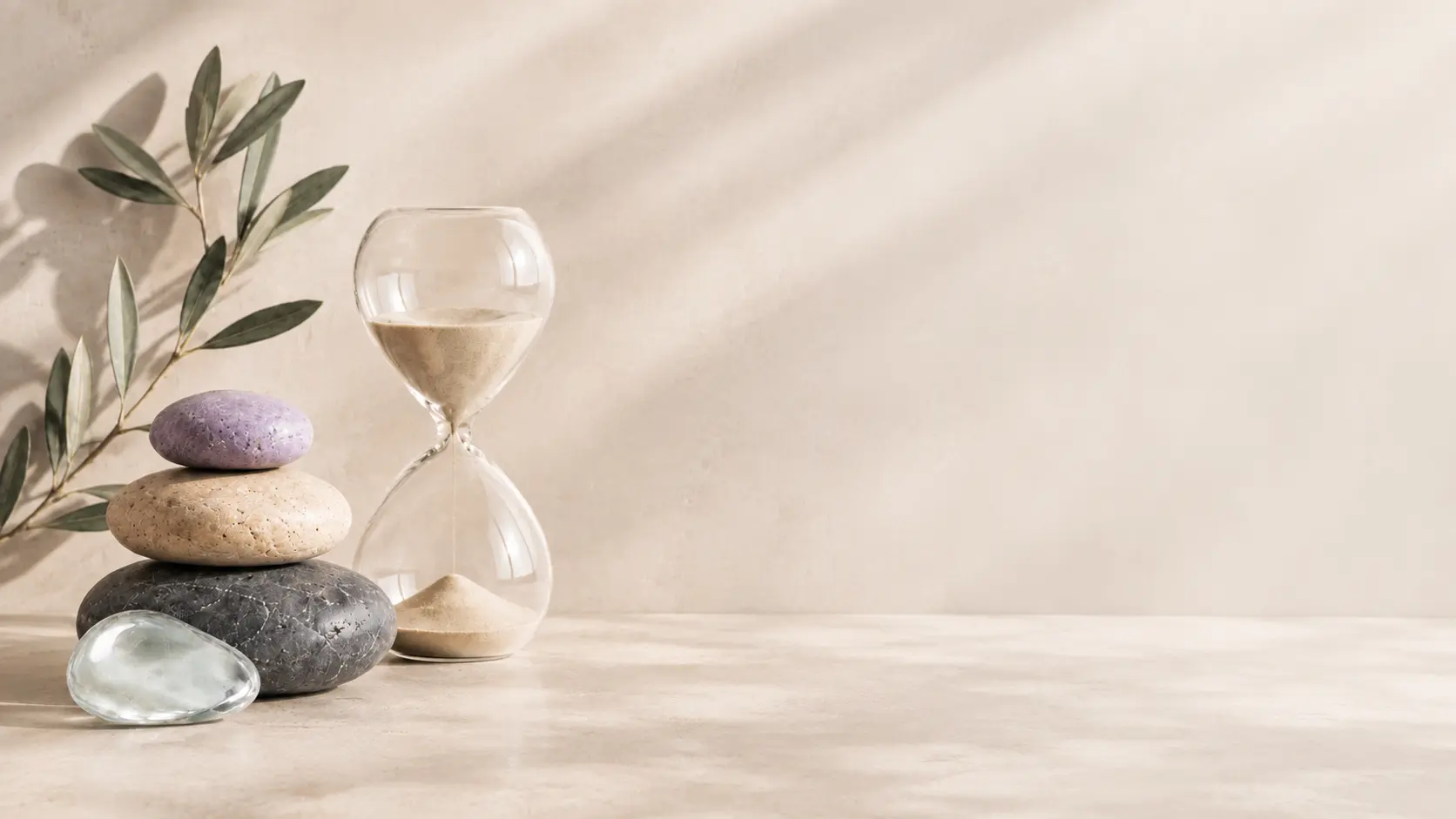 Stones and an hourglass in a quiet therapy setting